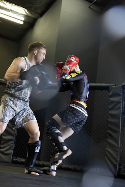 Athletes working through a live sparring round inside The Q MMA cage