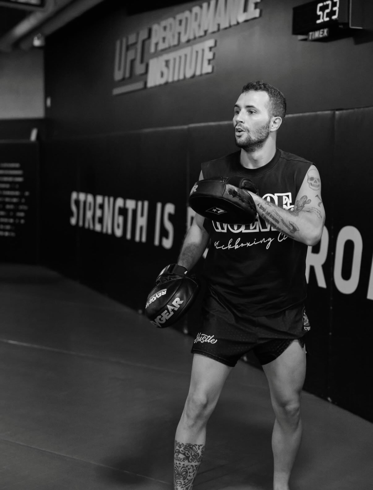 Matheus Naccache holding focus mitts during training